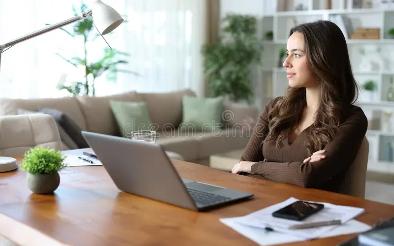 confident-teleworker-thinking-looking-away-folding-arms-home-464727756